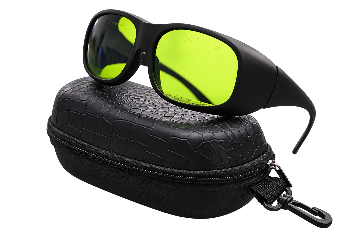 Angled view of black wraparound laser safety glasses with yellow-green lenses on a black zippered case with an attached clip, isolated on a transparent background.