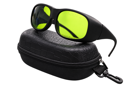 Angled view of black wraparound laser safety glasses with yellow-green lenses on a black zippered case with an attached clip, isolated on a transparent background.
